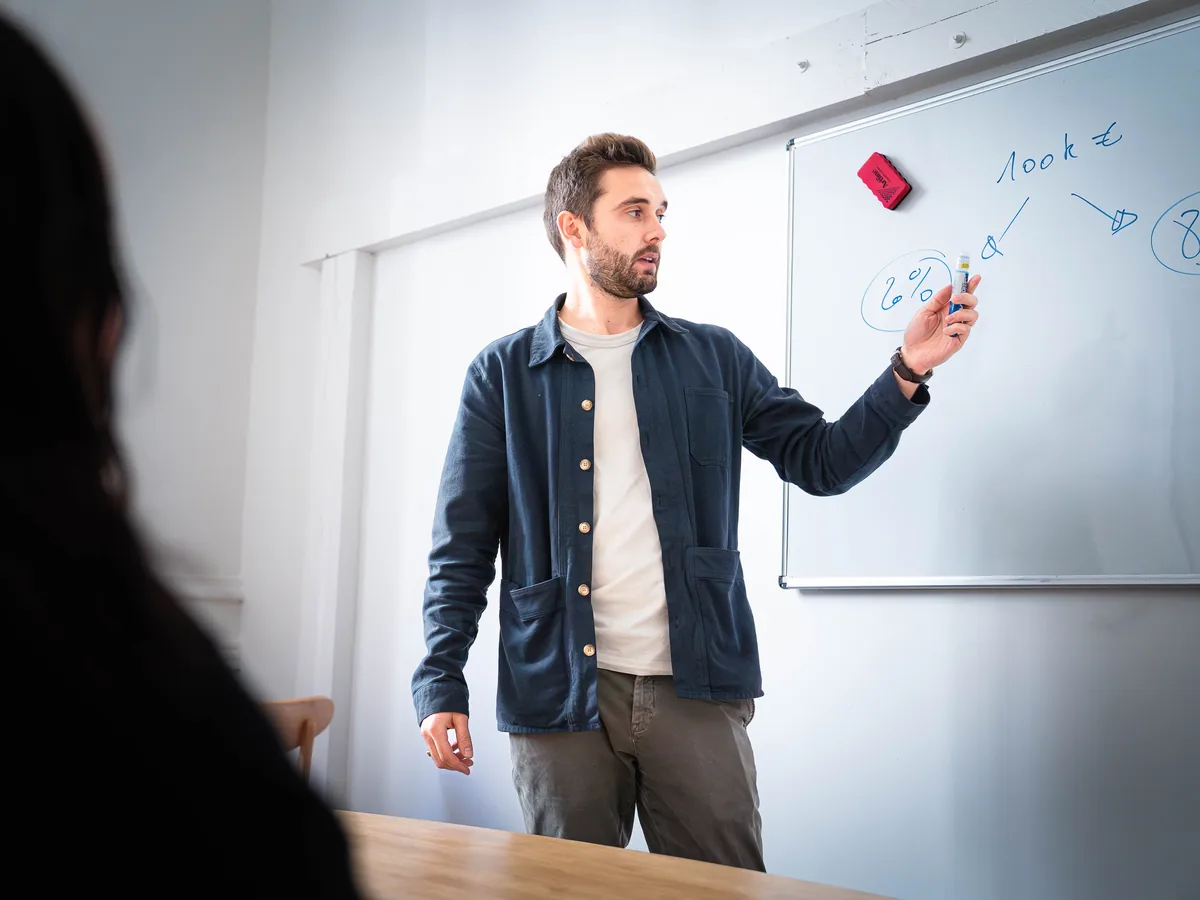 Coach Kwala détaillant au tableau la construction d’un objectif commercial